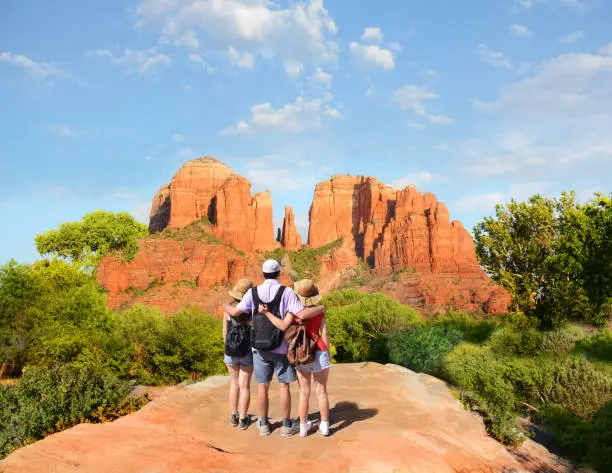 People looking at beautiful mountains landscape. Family on hiking trip enjoying view of  Cathedral Rock, Sedona, Arizona, USA