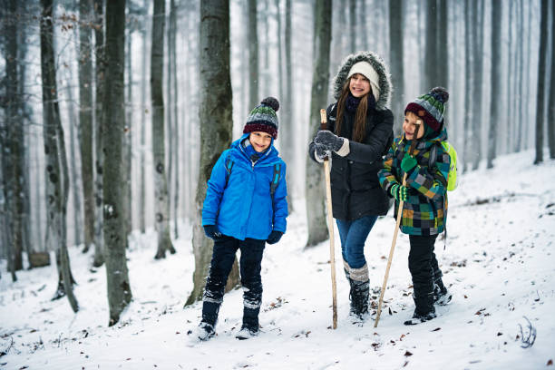 istock Kids hiking in misty winter forest 857437412
