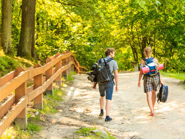 istock Hiking young couple with guitar backpack outdoor 857437466