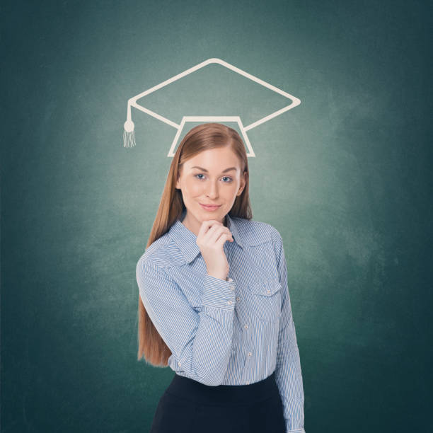 istock Female student with mortarboard icon on chalkboard 857437552