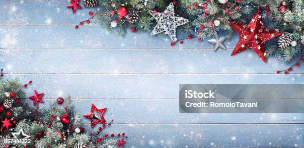 Christmas Background Fir Branches And Baubles On Snowy Plank Stock Photo - Download Image Now