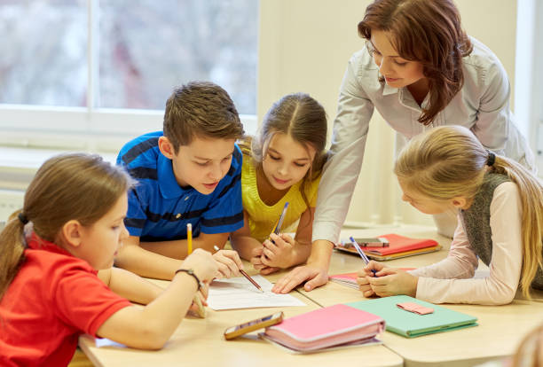 istock group of school kids writing test in classroom 857444982