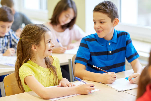istock group of school kids writing test in classroom 857445232