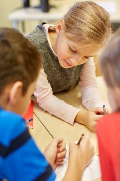 istock group of students talking and writing at school 857445880