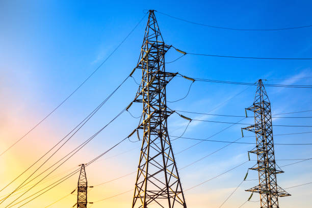 istock Pylons and transmission power lines on the blue sky background. 857446174