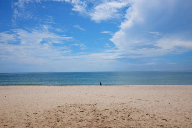 istock A man on Beach and blue ocean and clear blue sky 857446298