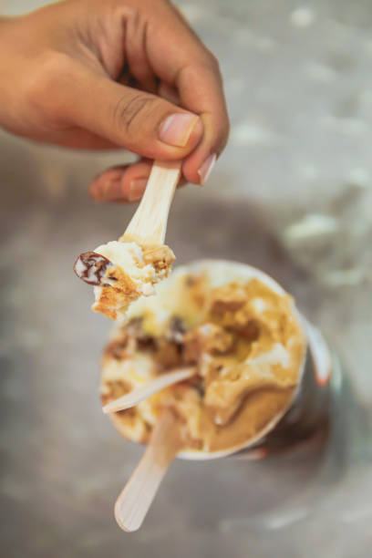 istock Young men eating ice cream from the cup 857448898