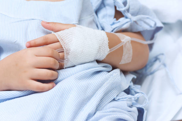 Hand of the sick child with saline solution with Space for text. Hand of the sick child with saline solution with Space for text. sick child hospital bed stock pictures, royalty-free photos & images