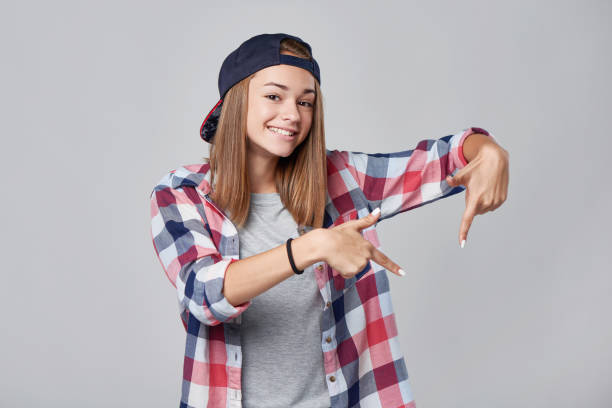 istock Teen girl pointing down at empty copy space 857456976