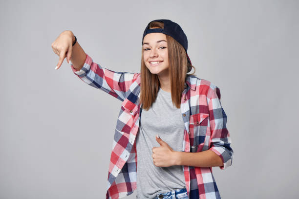 istock Teen girl pointing down at empty copy space 857457512