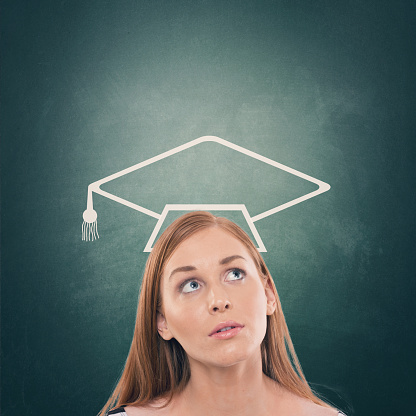 Thoughtful female student with mortarboard over her head