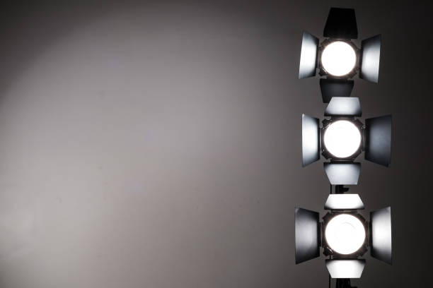 istock Several reflectors on the black background in photo studio. 857467876