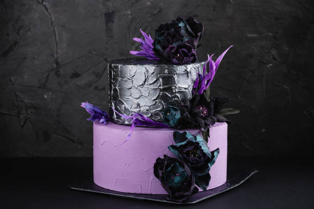 istock Artwork wedding cake with fake flowers on black background 857477630
