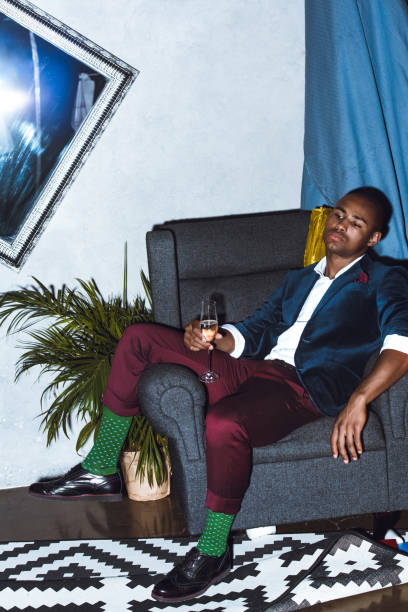 istock man sitting in armchair on party 857481436