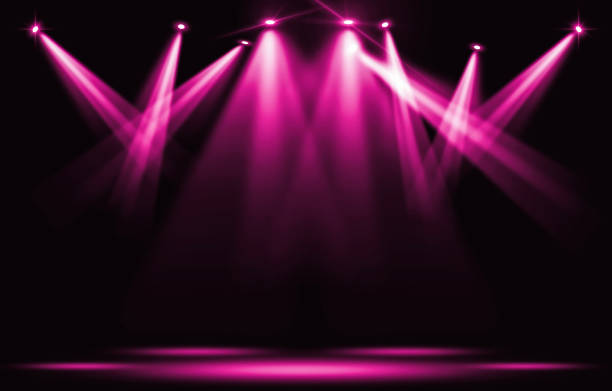 istock Stage lights. Pink violet spotlight strike through the darkness. 857481908