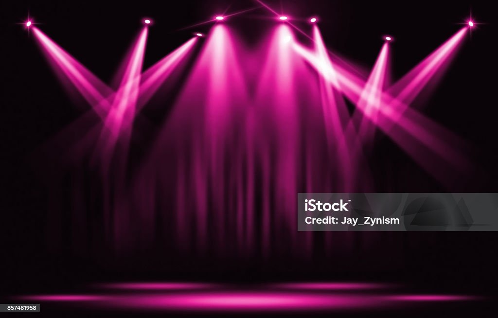Stage lights. Pink violet spotlight with certain through the darkness. Pink Color Stock Photo