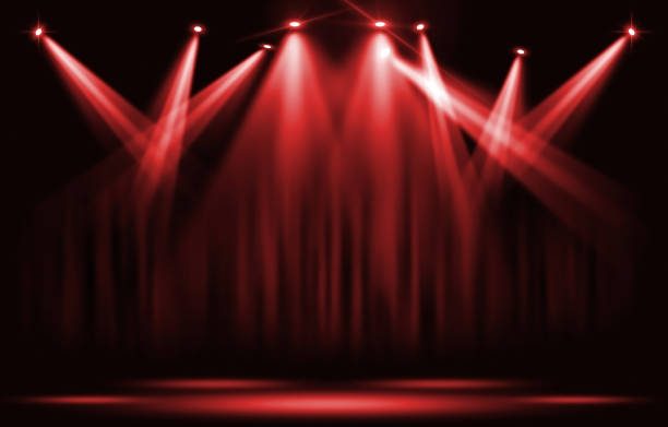 istock Stage lights. Red spotlight with certain through the darkness. 857482164