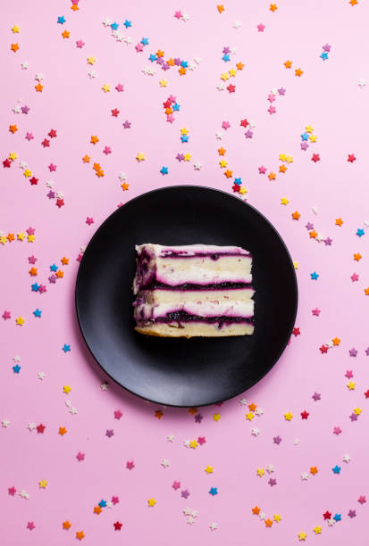 istock pieces of birthday cake on a pink 857482728