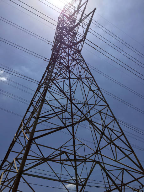 istock High Voltage Poles on blue sky and sunlight. 857489228