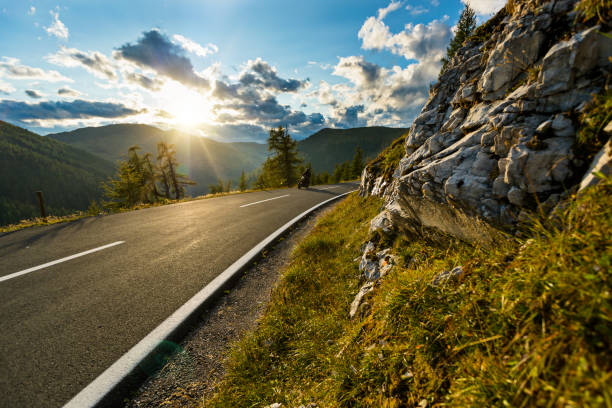 istock Motorcycle driver riding in Alpine highway, Nockalmstrasse, Austria, Europe 857490330