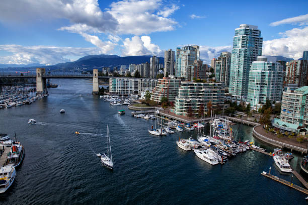 False creek in autumn, Vancouver, Canada Panoramic view of false creek in autumn in Vancouver, Canada canada flag blue sky clouds stock pictures, royalty-free photos & images