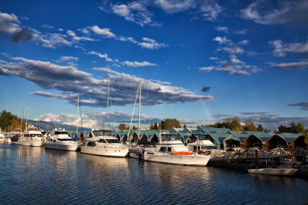 Rainbow over Vancouver marina,  Canada Vancouver marina in Stanley park on a sunny autumn afternoon. shadow british columbia landscape cloudscape stock pictures, royalty-free photos & images