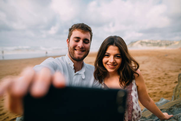 istock Young couple taking a selfie 857505224