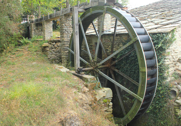 istock wheel of a water mill 857505490