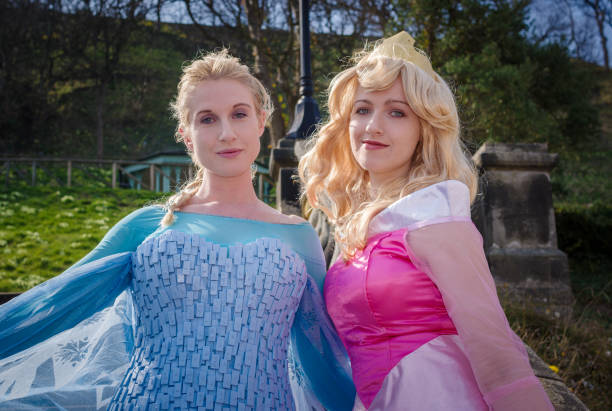 Female cosplayers as Disney Princesses Cosplayers dressed as 'Princess Elsa' from Frozen and 'Princess Aurora' from Sleeping Beauty at Sci-Fi Scarborough. cosplay character stock pictures, royalty-free photos & images