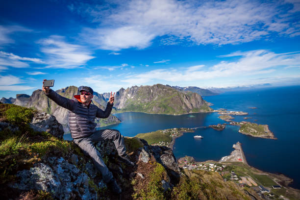istock Man on top of a mountain taking a selfie 857505846
