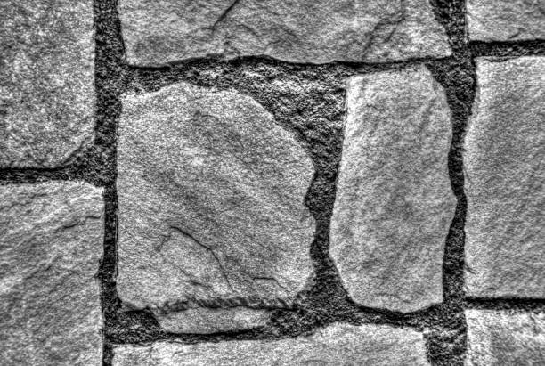 Stylish stone wall background in black and white closeup