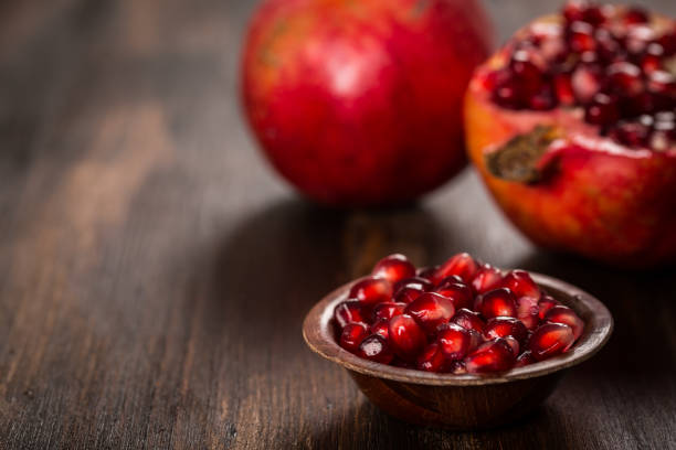 istock Pomegranate fruit on wooden vintage background 857514722