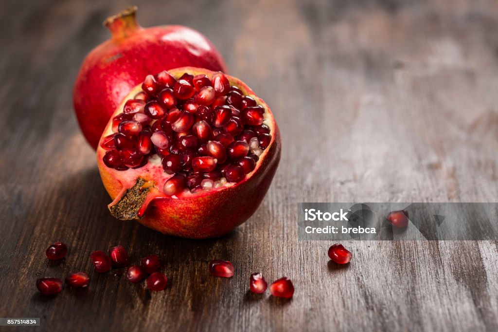 Pomegranate fruit on wooden vintage background Pomegranate Stock Photo