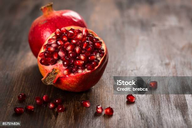 Pomegranate Fruit On Wooden Vintage Background Stock Photo - Download Image Now - Pomegranate, Red, Fruit