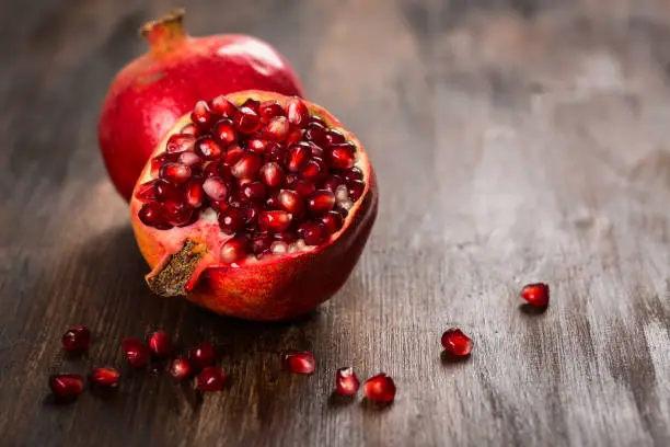 Pomegranate fruit on wooden vintage background