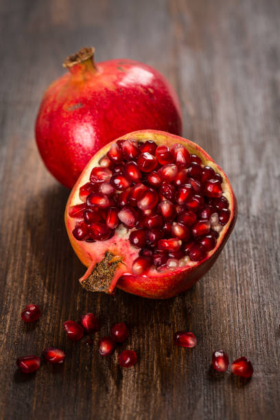 istock Pomegranate fruit on wooden vintage background 857514860