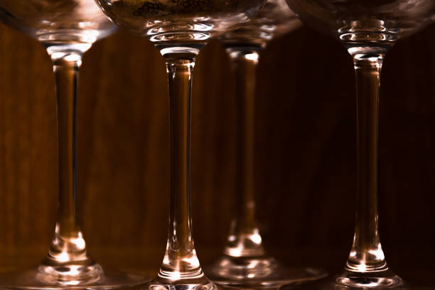 Catering, party concept: close-up image of wine glasses on a dark wooden background. Selective focus.