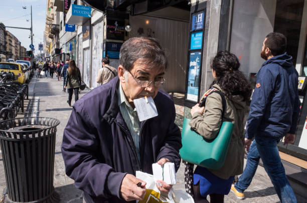 Milano, Corso Buenos Aires, ITALIA - May 2016: old man trying to collect cards in the street
