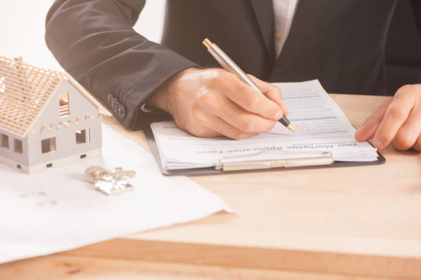 istock Mortgage Application Form - Hand Filling The Document Closeup 857526186