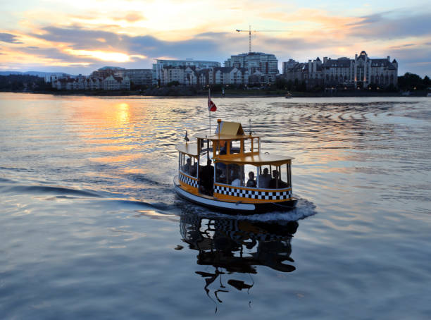 Water taxi at sunset.  Victoria Harbor, British Columbia, Canada. stock photo