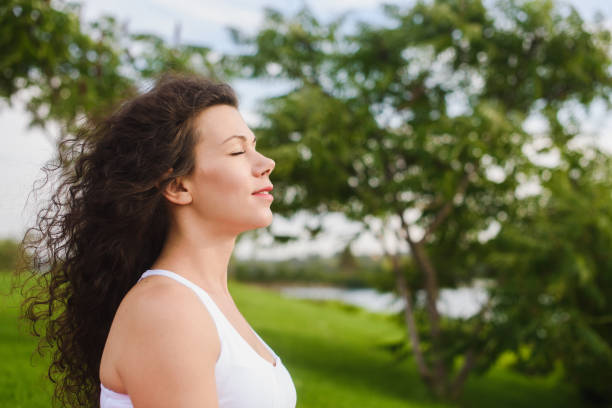 istock Woman meditating with her eyes closed 857527022