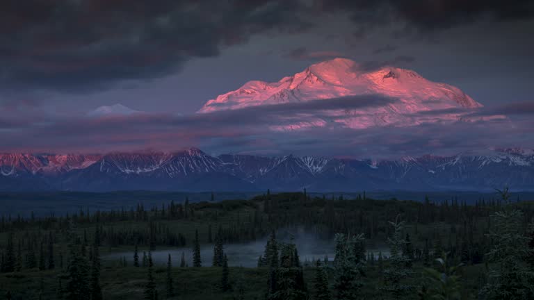 Time lapse of Mount Denali (McKinley) at sunrise, starts off pink and soon to be covered by clouds