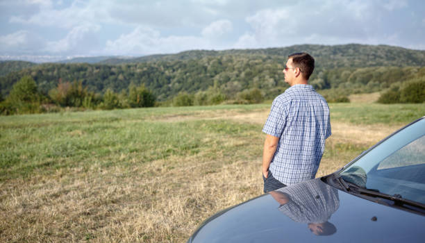 istock Road trip break after long drive. man enjoys sunset 857533542