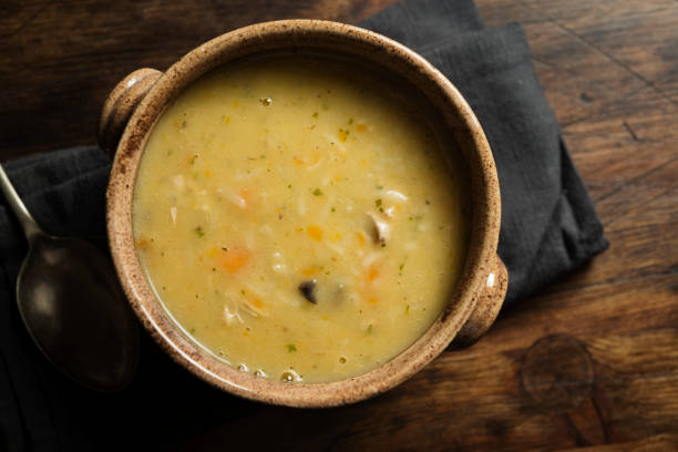 bowl of Chicken and Vegetable soup. bowl of Chicken and Vegetable soup in a rustic brown soup bowl. chicken soup stock pictures, royalty-free photos & images