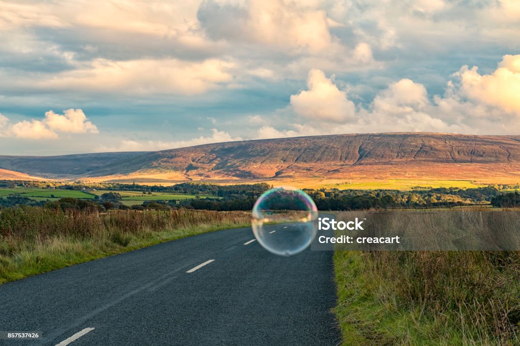 Country road with a floating bubble. Surrealism Stock Photo