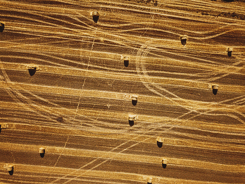 Aerial view of agriculture field with straw bales