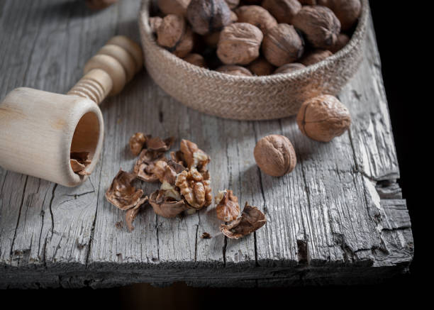 istock Nuts on bold in foreground on aged wooden table 857548866