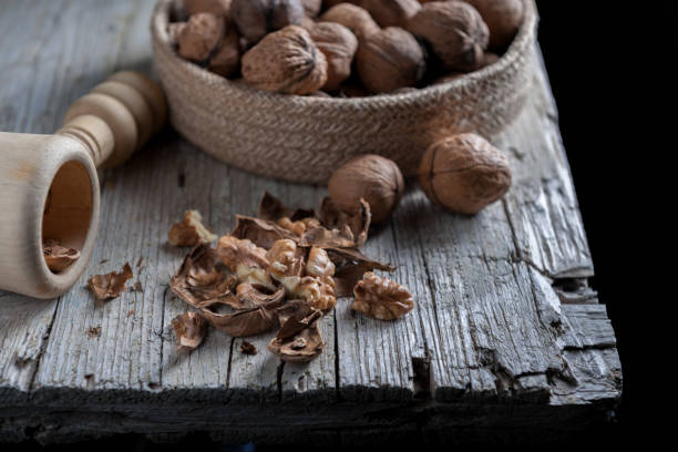 istock Nuts on bold in foreground on aged wooden table 857548920