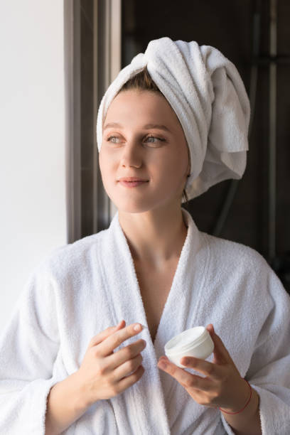 istock woman applying face cream 857549002