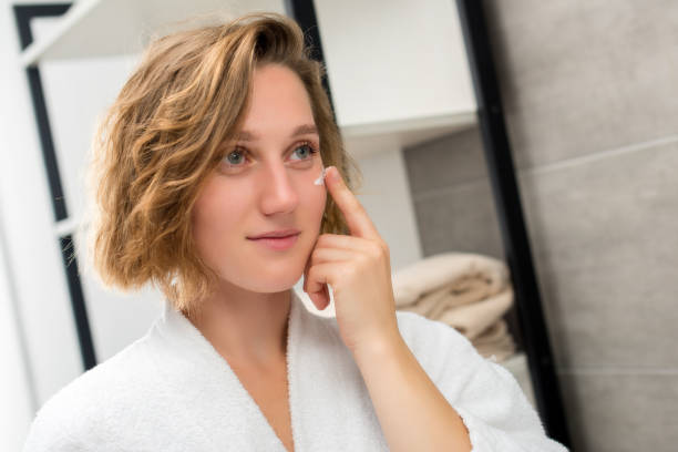 istock woman applying face cream 857549554